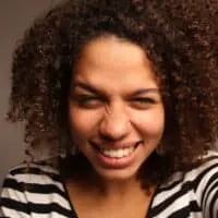 African American female wearing semi-permanent hair dye on her medium brown natural curls.