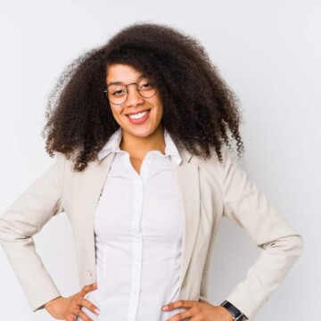 Young African American businesswoman with long hair wearing her curls loose creating a professional look.