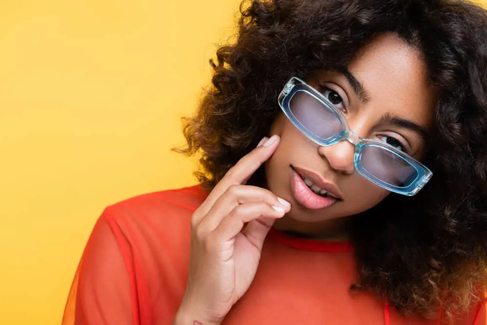 A light-skinned, young black woman with medium-length hair after trimming her baby hairs.