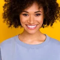 A pretty young American female wearing a good hair mask with nourishing ingredients like two avocados.