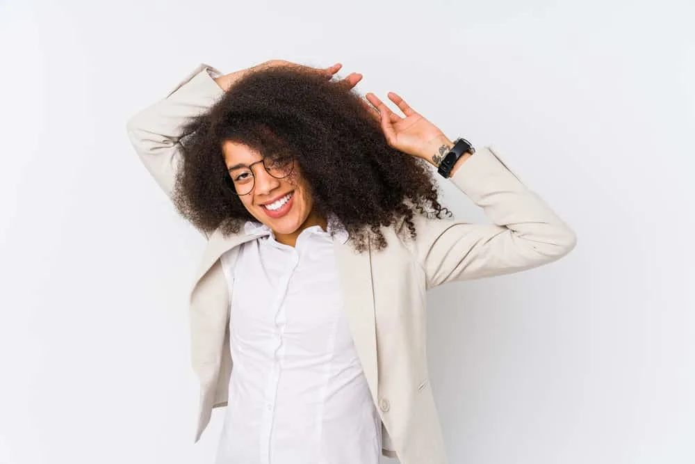 Black lady with longer hair than most black women deciding not to wear her hair straight in a corporate setting.