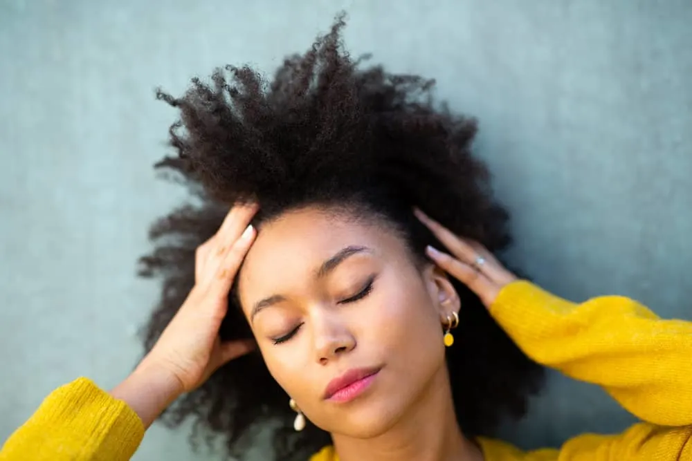 African American female with a kinky hair texture wearing makeup for black skin.