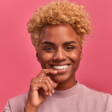 Cute black girl with extremely curly hair styled with mineral oil, lanolin wax, and organic compounds.