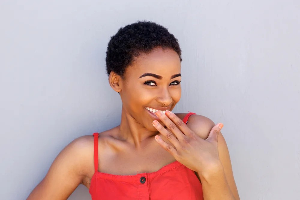 A young lady after washing her wet hair is wearing her own hair in very short two-strand twists with a little gel.