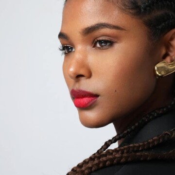 Cute black woman with her natural hair combined with synthetic hair extensions to maintain cornrows for two months.