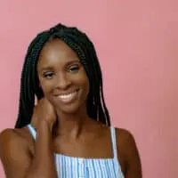 African American female wearing braided hair strands to protect her own hair and encourage hair growth.