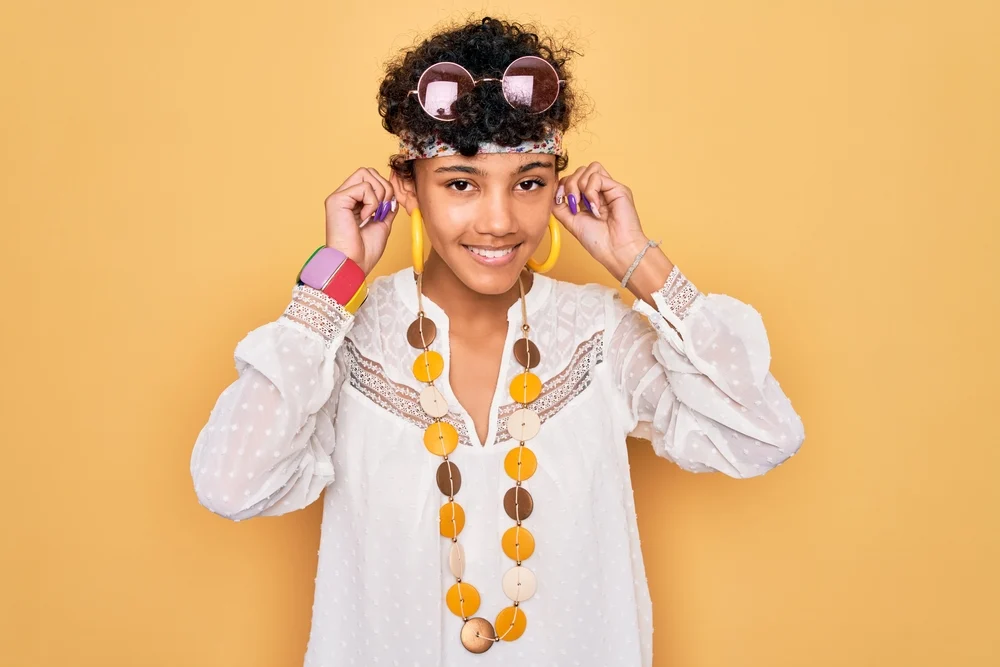 A young dark African girl wearing a bixie hairstyle with texture spray to add depth.