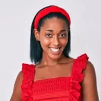 A cute young black woman with frizzy hair after getting a keratin treatment and letting her hair air dry.