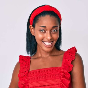 A cute young black woman with frizzy hair after getting a keratin treatment and letting her hair air dry.