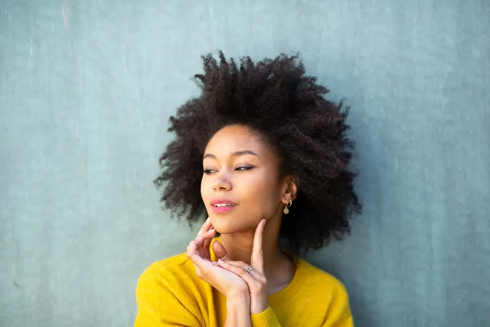 A beautiful black woman showing off her textured hair after removing box braids that were worn for six-weeks.