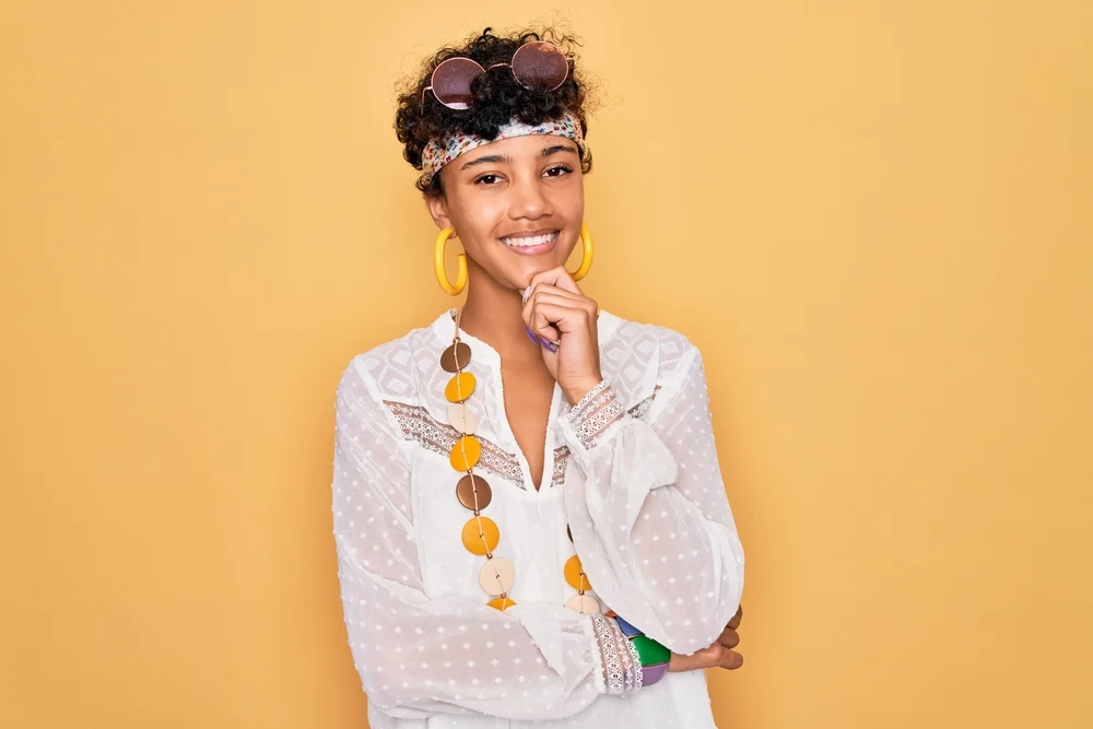 This African-American woman's hair is medium-thick and has been texturized with texture spray to add depth.