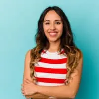 A cute young Mexican lady with semi-permanent hair dye on her dark brown ombre-colored hair follicles.