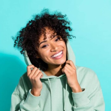 A beautiful black woman with 3B natural hair has an itchy scalp after allowing her hair's natural oils to build up.