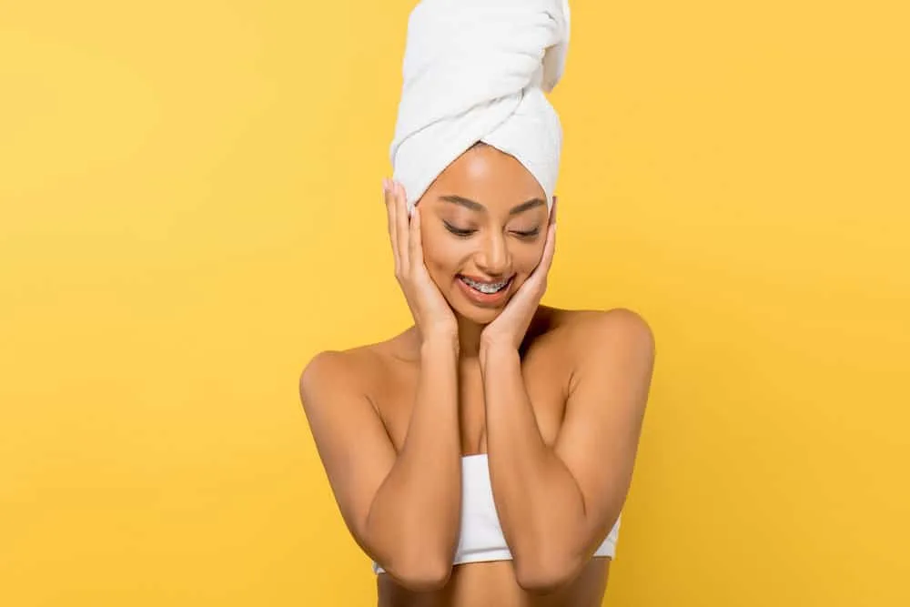 African American female that used leave-in hair products before plopping using the head and flip technique.