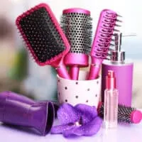 Hair styling tools that include a round brush, hair spray, brush cleaner, new hair dryer, and liquid soap.