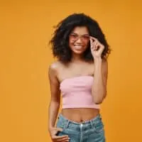 African American female with long hair treats her hair regularly with sulfate-free shampoo and conditioner.