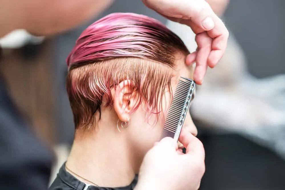 White lady with hair dye stains on the right-side of her neck that was removed with a makeup remover pad.