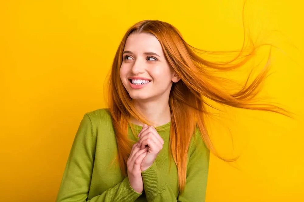 A cute white girl after changing her hair washing regimen to calm oil production on her generally straight strands.