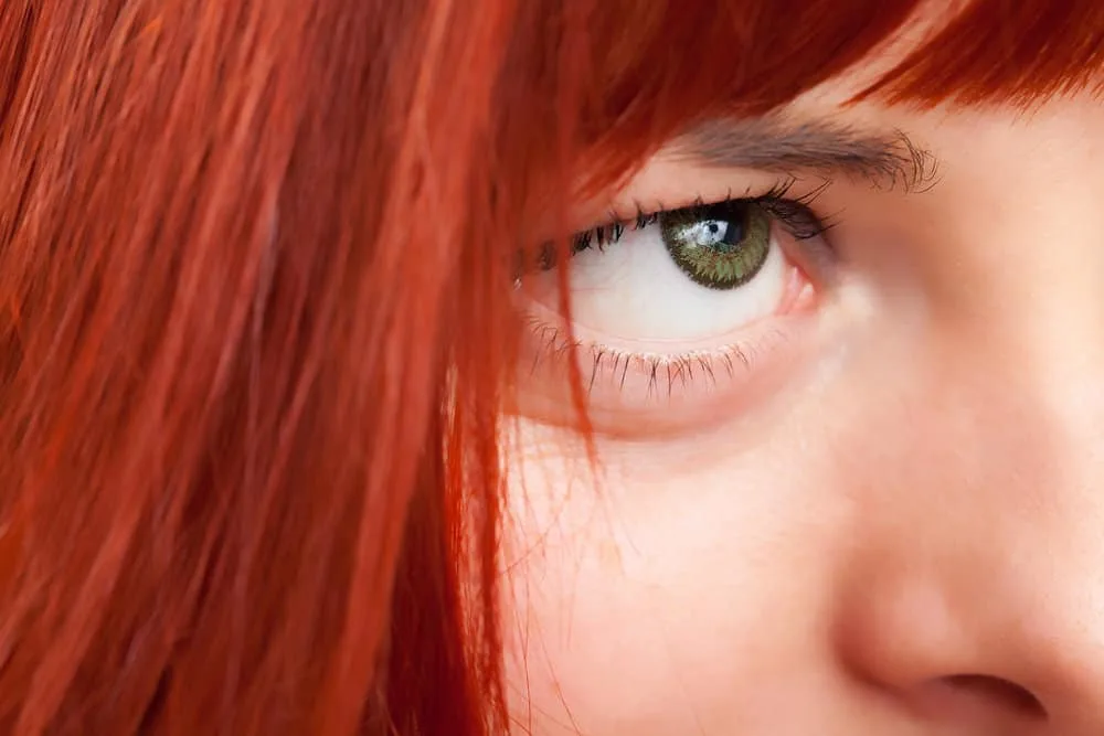 A lady with a unique red hair color mixed blue envy and pink fetish hair dyes together to create lovely red hair.