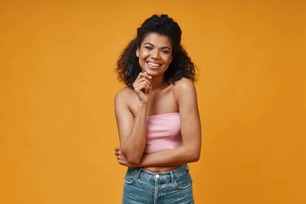 African American female with shoulder-length short hair styled with coconut oil and organic hair products.