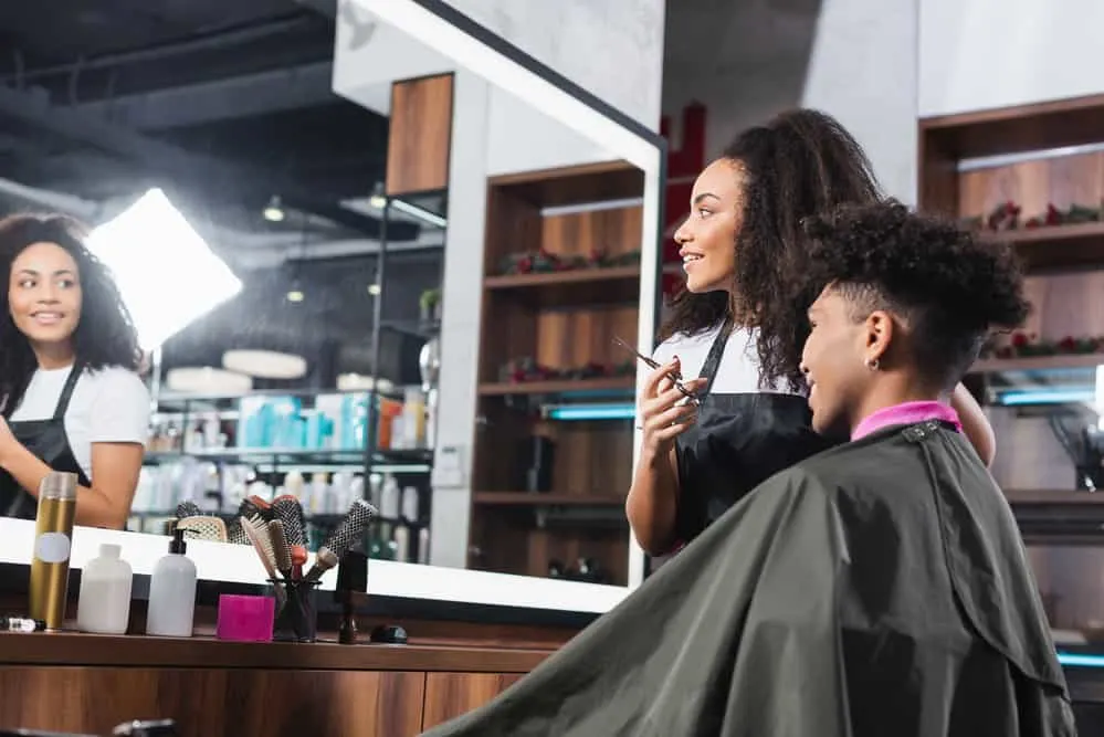 A black man getting a haircut in his local barbershop found a coupon for new clients in the local paper. 