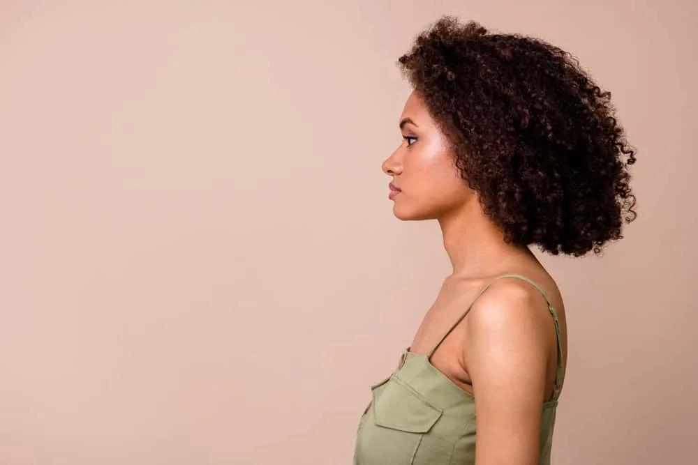 A young lady with brown vibrant hair fades nicely after washing it with a regular moisturizing shampoo.