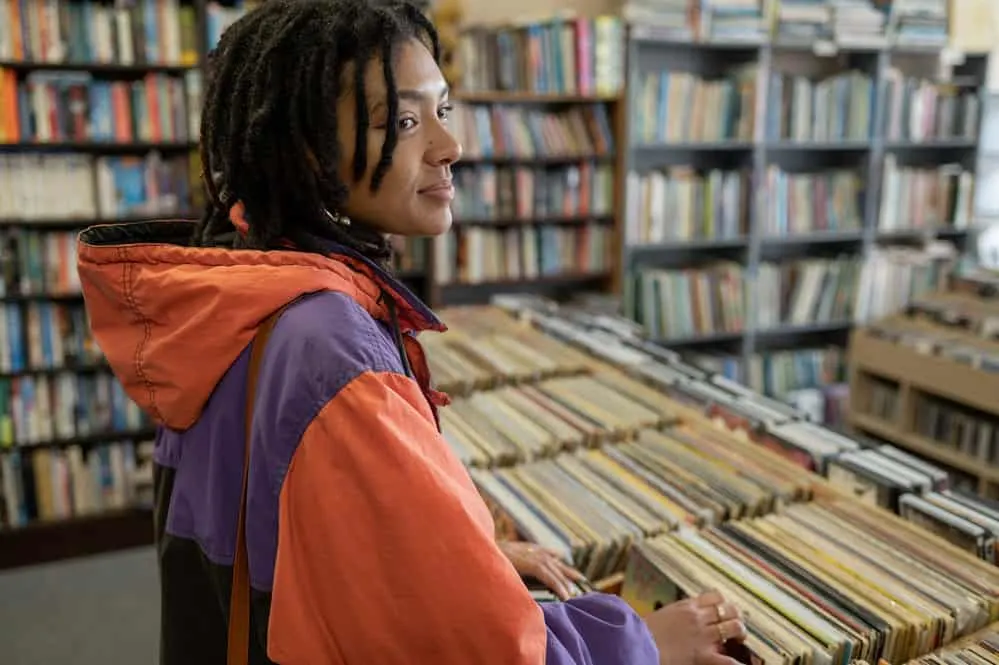 A black woman wearing loose hair in a dreadlock hairstyle styled with a leave-in conditioner to prevent dryness.