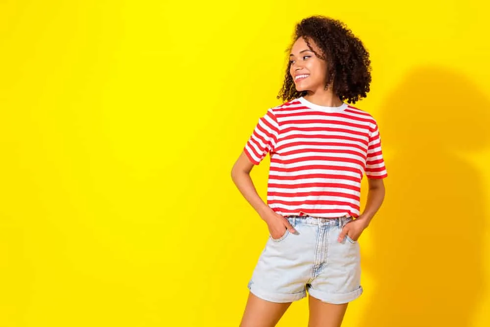 A curly girl cleaned her hair with a rich lather shampoo with a proprietary strengthening complex designed to moisturize.