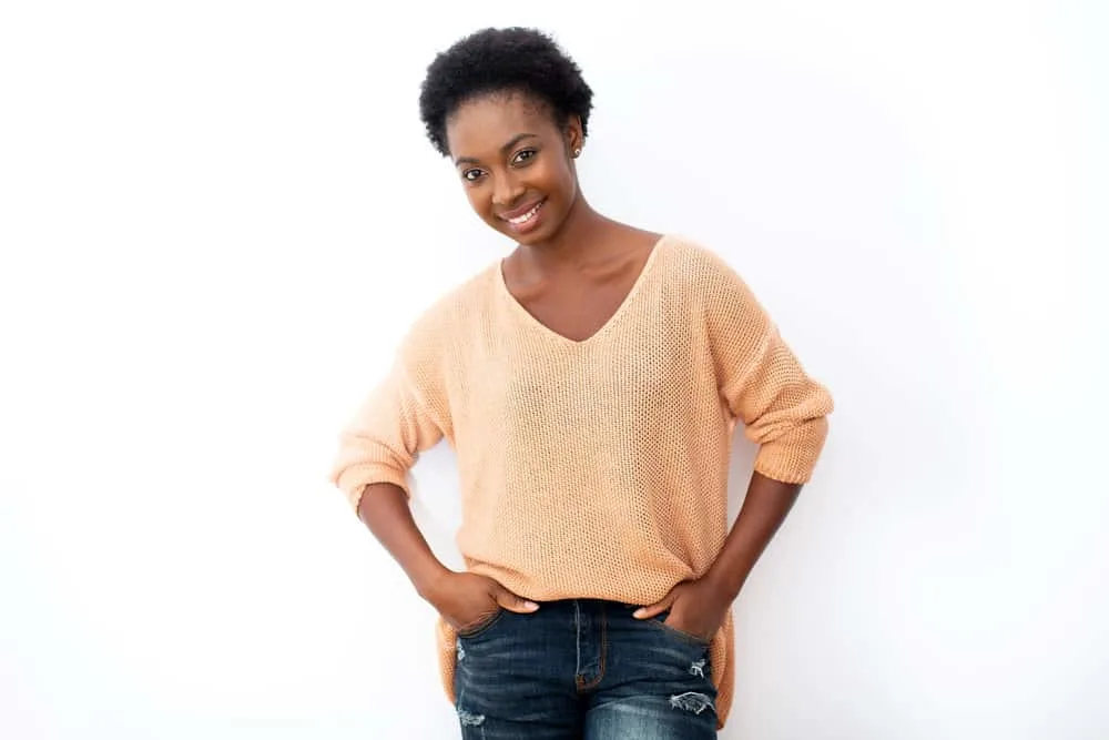 A beautiful African American female with a coily hair pattern with sharp angles styled with coconut oil.