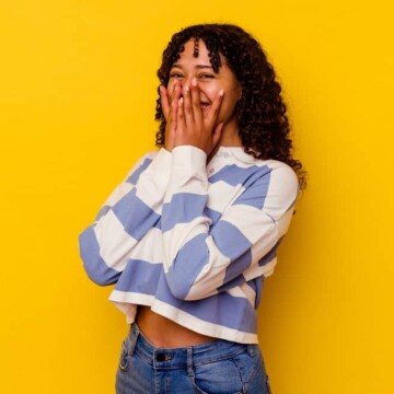 A young mixed-race female with loose and scaly skin on her scalp, wondering if it will cause rapid hair growth.