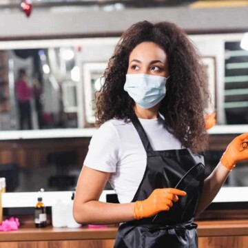 A light-skinned black lady with healthy hair gives women's haircuts and men's haircuts by appointment at a local salon.