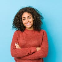 A young African American female with fine hair used too much conditioner on trying to keep her hair healthy.