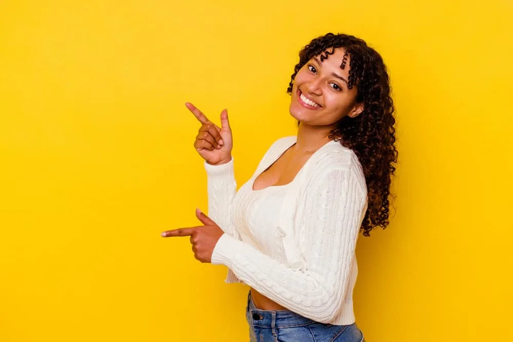 A black girl that used to wear her hair completely straight now embraces her naturally curly original texture.