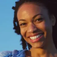 A black lady wearing a two-strand twist protective style after getting her hair twisted by a natural hair stylist.