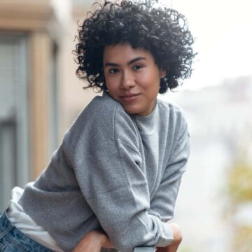 A cute female with beautiful curly hair follicles wearing her curls in a wash-n-go style created.