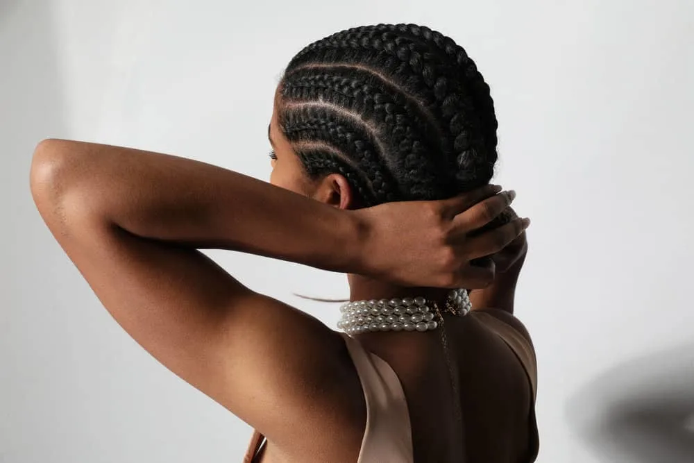 A beautiful young woman preparing for bedtime is about to wrap her hair in a silk scarf to retain moisture.