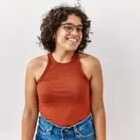 Hispanic woman with a darker complexion and naturally curly hair (i.e., textured hair) from Mexico City, Latin America.