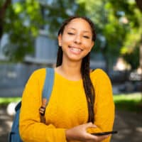 A young black girl is researching ways to style dookie braids and other braiding styles with hair accessories.