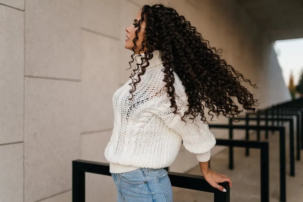 A lady with a luxurious DIY perm created with perm rods from Amazon using a YouTube perming process tutorial.