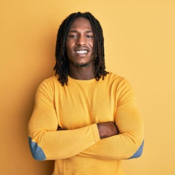 African American male with a tight curl pattern is wearing freeform dreadlocks on his 4B natural hair texture.