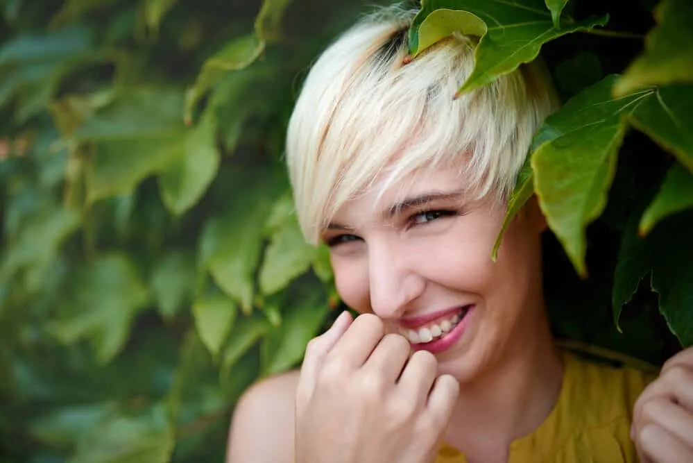 A young woman at the pixie-cut stage gets frequent trims from her stylist on her luscious locks.