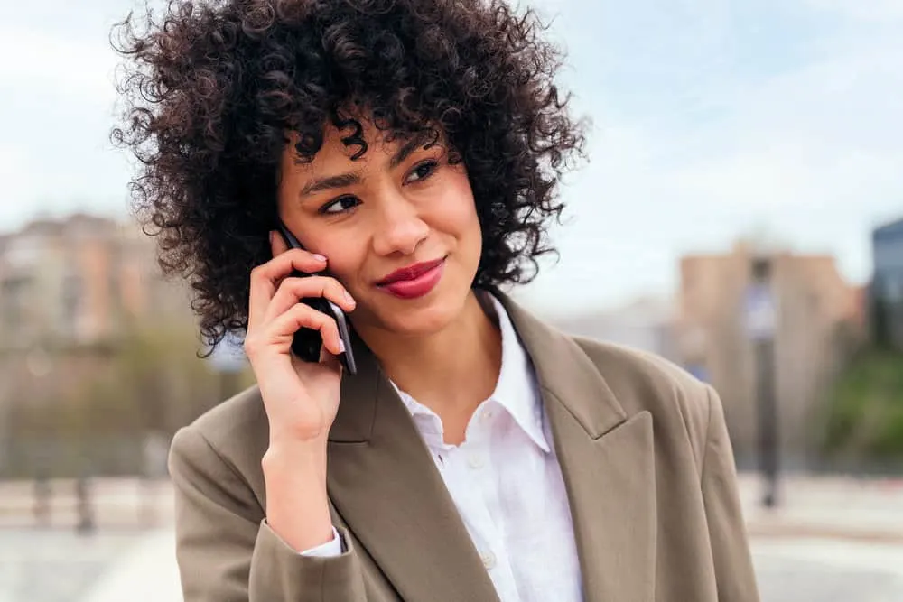 A cute Latin female with thin hair styled with a round brush that can be used on wet or dry hair strands.