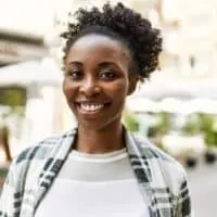 African American female with dark hair after using conventional hair dye to make her brown hair a deep black color.