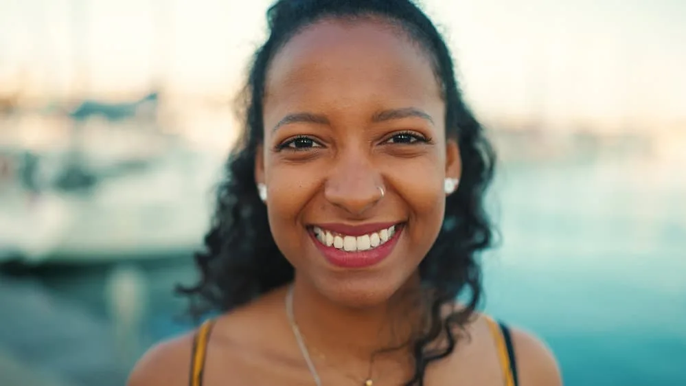 A delightful black female with multiple hair types on a head full of gorgeous curls on vibrant, shiny hair strands. 