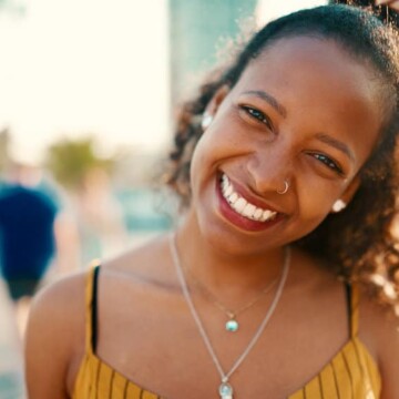 A cute black girl with a great smile has been using rice water for hair care purposes for over a year and a half.