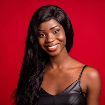 A young black female wearing a natural hair lace front wig made from real human hair with a natural-looking hairline.