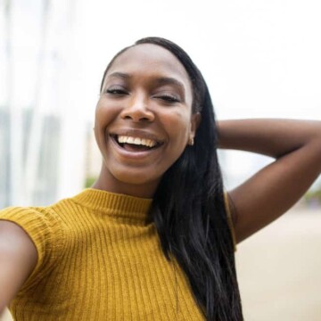 A cute black female with healthy hair has a straight hair type even though her hair is not curly anymore.