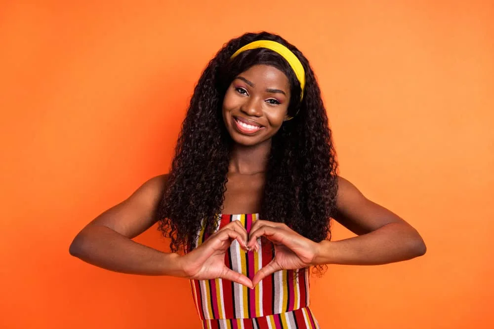 The lighter-density wig worn by this African American female is a full lace wig creating a natural and perfect look.