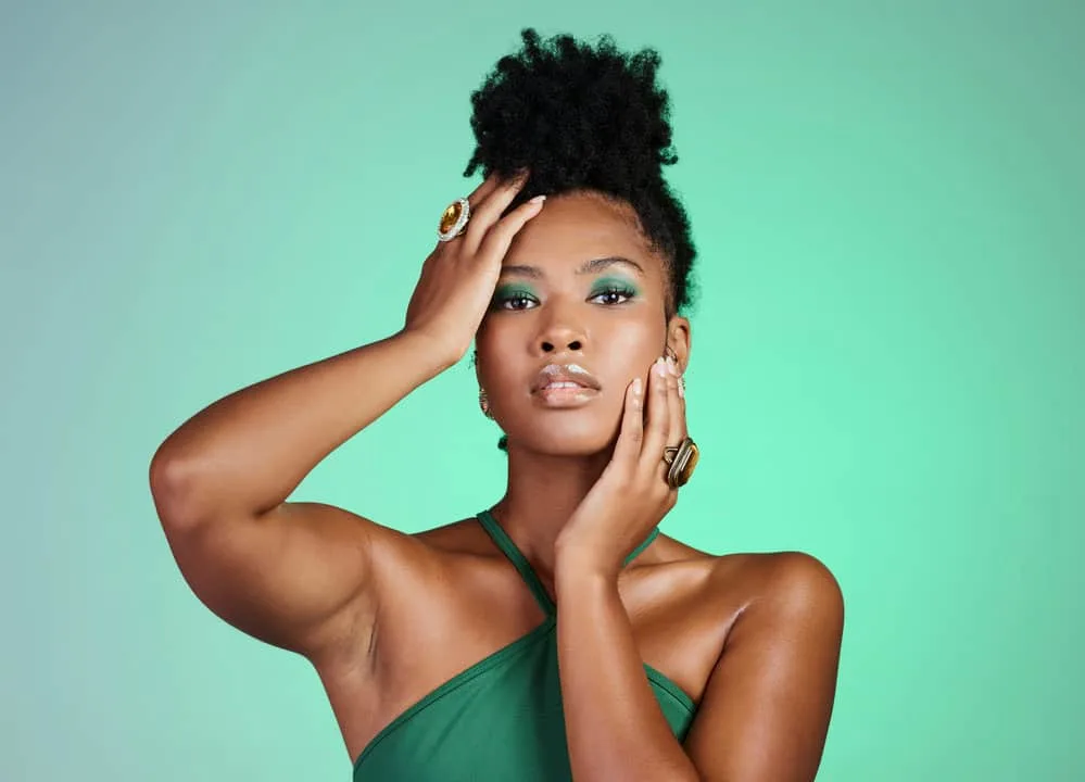 A black woman allowing her natural texture to shine after removing braiding hair used to create faux locs.