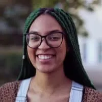 A young black woman with tight braids treated her braided hair follicles with an apple cider vinegar rinse.